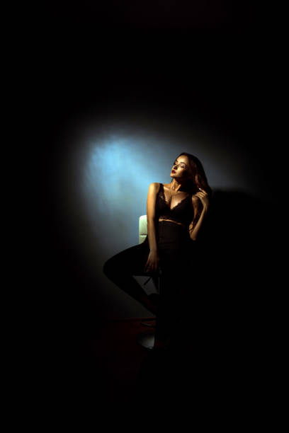 istock Gorgeous lady with curly hairstyle in dark studio 1200054868