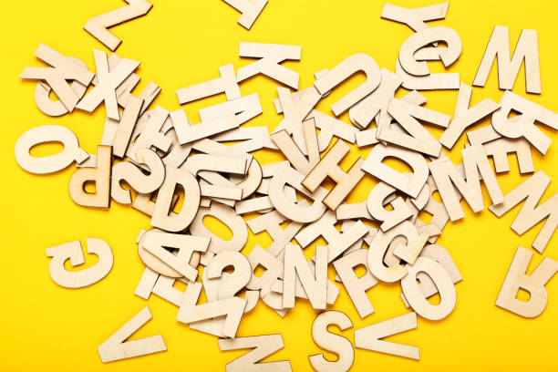 istock Wooden letters on yellow background 1200055007