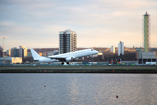 Commercial aircraft taking off the airport in evening light conditions.