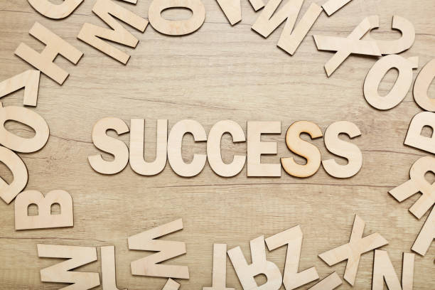 istock Word success by wooden letters on brown table 1200055624