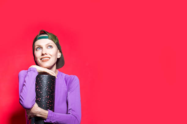 istock attractive fit woman with foam roller 1200057538