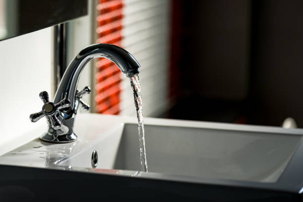 istock Faucet and water flow on bathroom 1200057808