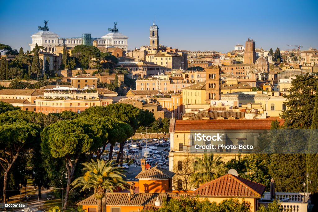 The sunset light illuminates the Capitol Hill and the Vittoriano in Rome Rome, Italy -- The warm light of sunset illuminates the area of the hill of the Capitol, the Altare della Patria (Vittoriano) and the Trajan's Forum, in the historic heart of the Eternal City, in a panoramic photo taken from the Aventine hill. HD format image. Italy Stock Photo
