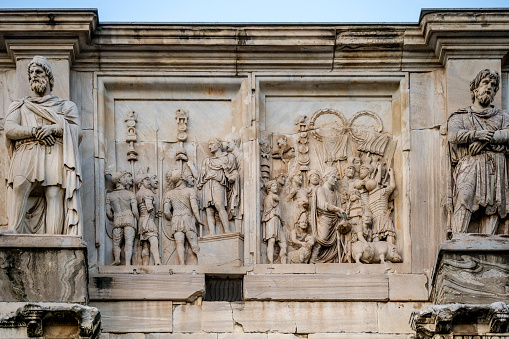 Rome, Italy -- A detailed view of the famous Arch of Constantine, near the Colosseum. The largest triumphal arch of the ancient world celebrates the victory of Emperor Constantine over Maxentius in 312 AD. in the battle of Ponte Milvio. The international tourist guide TripAdvisor has proclaimed the Colosseum as the most visited monument in the world in 2019, according to data collected from the reservations of visitors and tourists, surpassing famous tourist destinations such as the Louvre Museum in Paris and the Vatican Museums. Image in HD format.