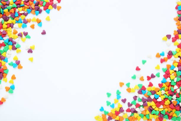 istock Colorful heart shaped sprinkles on white background 1200063433
