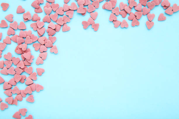 istock Heart shaped sprinkles on blue background 1200063454