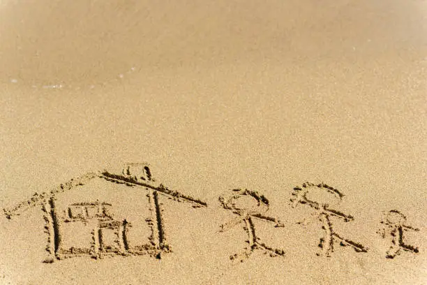 Photo of Family and House Drawing On Beach Sand