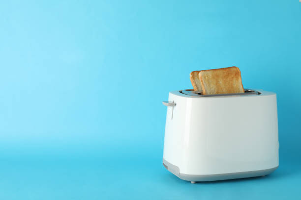 istock Toaster with bread slices on blue background, space for text 1200067213