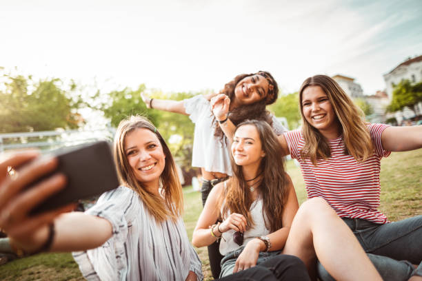 istock teens using the smartphone in the city taking a selfie 1200068784