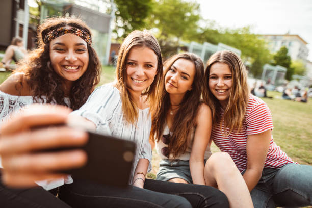 istock teens using the smartphone in the city taking a selfie 1200068813