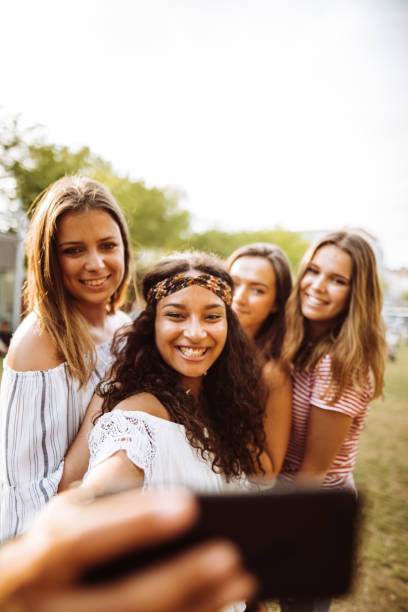 istock teens using the smartphone in the city taking a selfie 1200069457