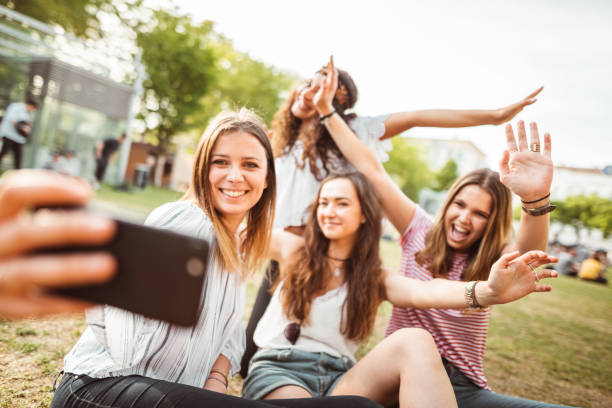 istock teens using the smartphone in the city taking a selfie 1200069499