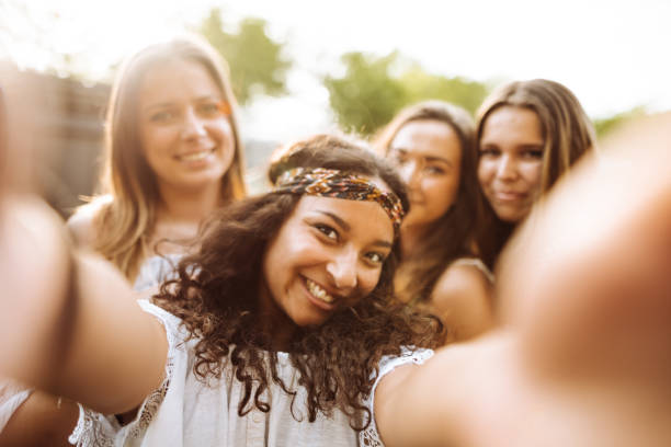 istock teens using the smartphone in the city taking a selfie 1200069530
