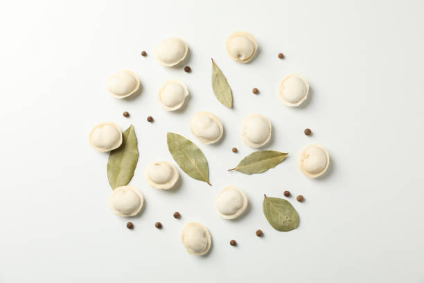 istock Raw dumplings and spices on white background, space for text 1200069546
