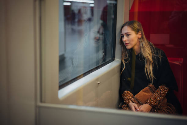 istock Smiling woman traveling by train 1200069887