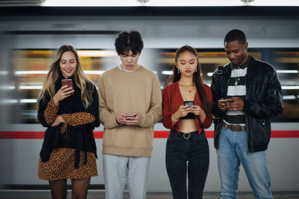 istock Multi-ethnic friends using cellphones at subway 1200069977