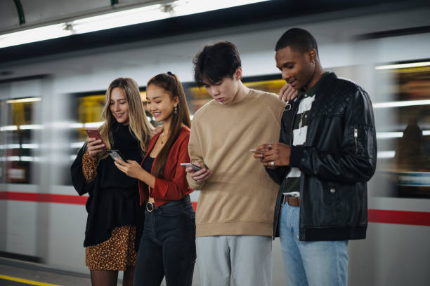 istock Multi-ethnic friends using cellphones at subway 1200070095