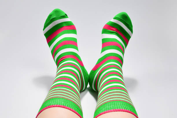 istock Woman in green socks isolated on white background. Top view. 1200071003