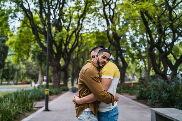 istock Gay couple embracing in park 1200071224