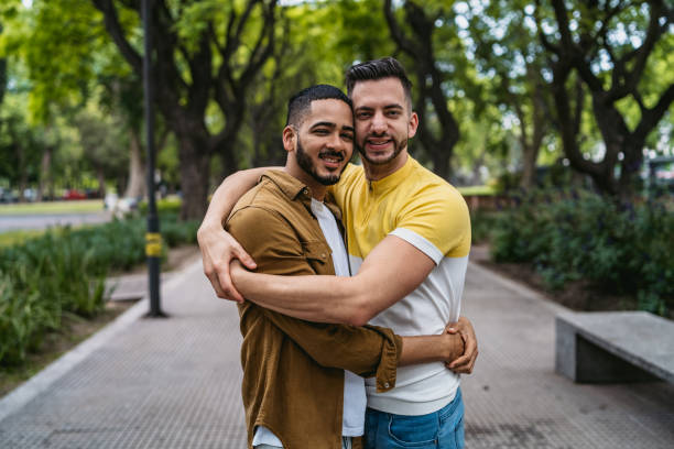 istock Gay couple embracing in park 1200071240