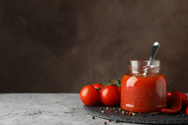 istock Bowl of chilli sauce, ingredients on gray background, space for text 1200071644