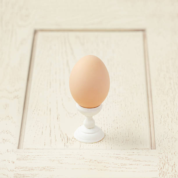 istock One egg wooden stand. Getting ready for the Easter holiday. 1200072721