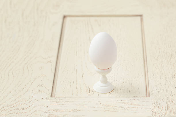 istock One egg wooden stand. Getting ready for the Easter holiday. 1200072725