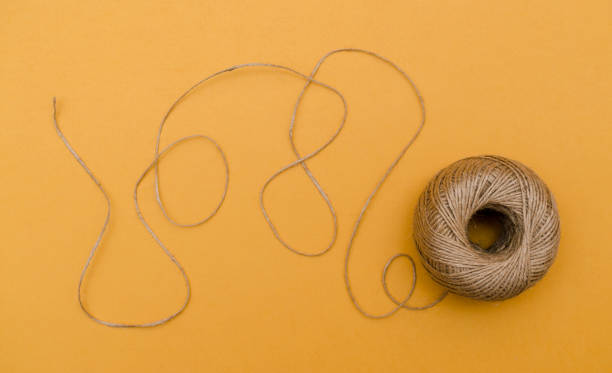 istock Hemp cord, jute twine on white paper backgound 1200073100