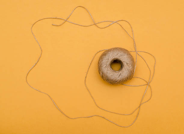 istock Hemp cord, jute twine on white paper backgound 1200074382