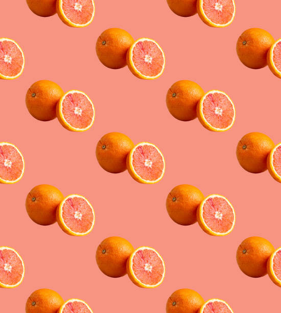 istock Fresh red orange or grapefruit on a peach color background. Pattern seamless tropical fruit photo. 1200078486