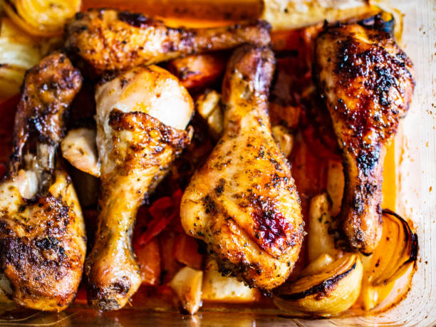 istock Roast chicken drumsticks and vegetables in glass pot 1200079503
