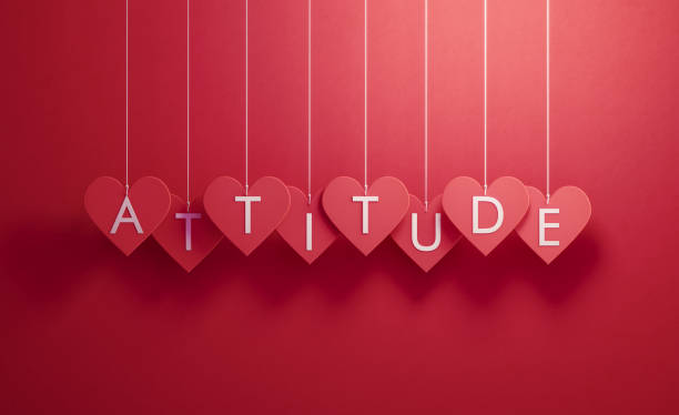 istock Attitude Writes over Red Heart Shapes Hanging over Red Background 1200080221