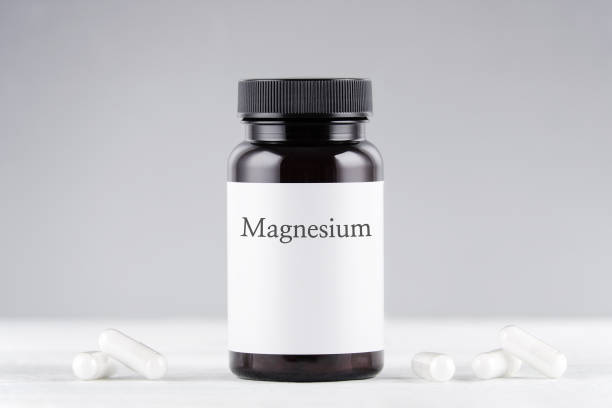 istock nutritional supplement magnesium bottle and capsules on gray 1200081206