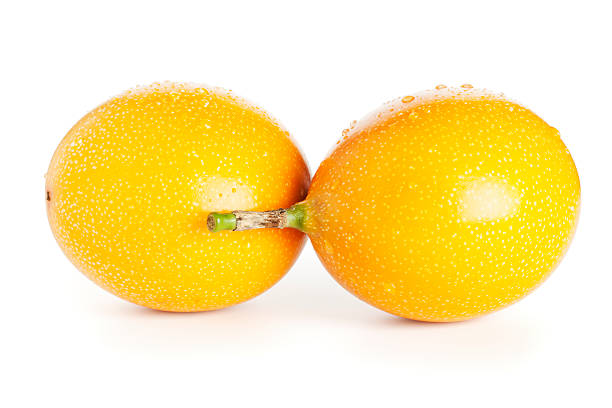 Two fresh grenadilla fruits with water drops isolated on white background. Find similar images here: