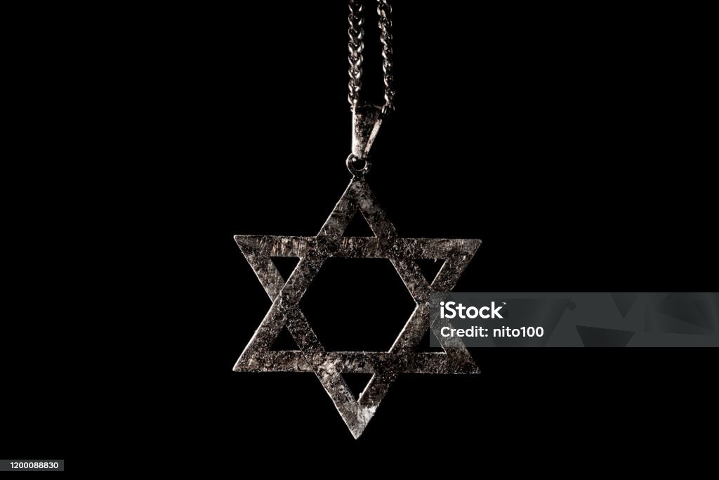 pendant in the shape of the star of david closeup of an old and rusty pendant in the shape of the star of david on a black background Star Of David Stock Photo