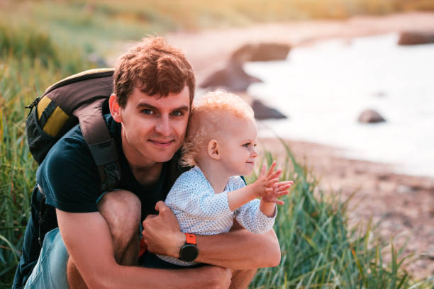 istock Young father and toddler boy playing on seaside. 1200090056