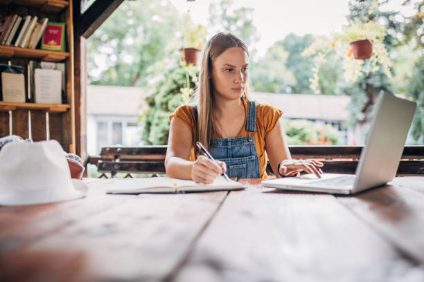 istock Young woman student studying outdoors 1200090452