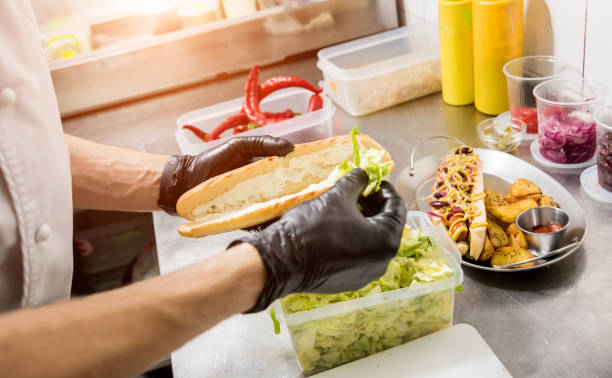 istock The chef cooking hot dog on a grill. Restaurant. 1200090463