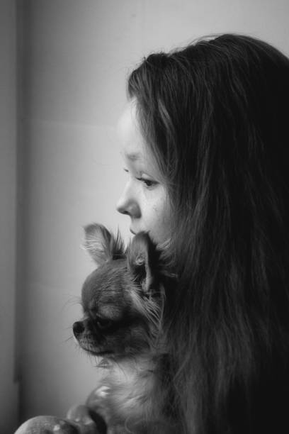istock A girl with a puppy in black and white 1200091321