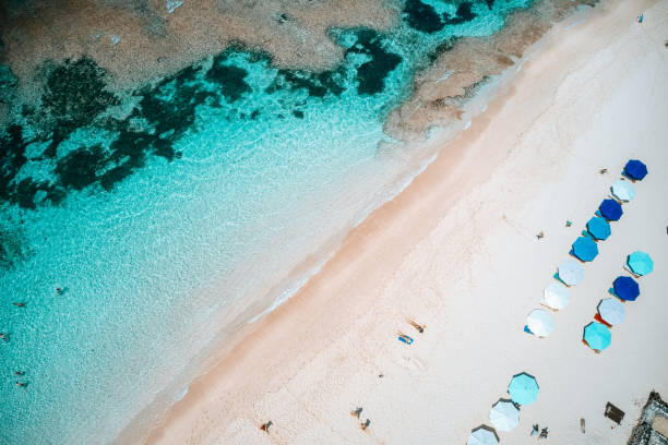 istock Beach umbrellas and blue ocean. Beach scene from above 1200091552