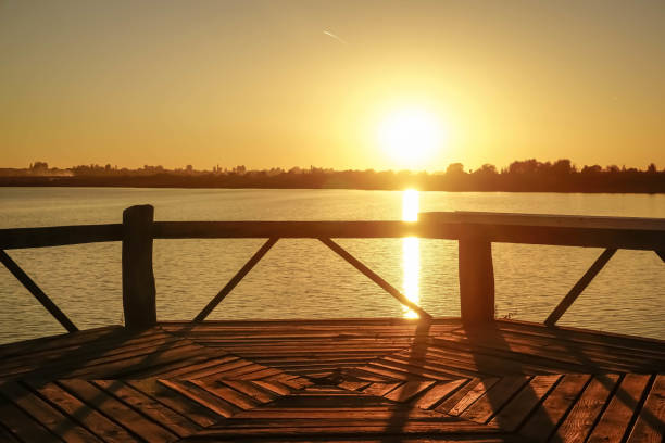 istock Beach gazebo and sunset over the lake 1200094681