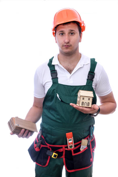 istock Worker with wooden toy house and samplers 1200095359