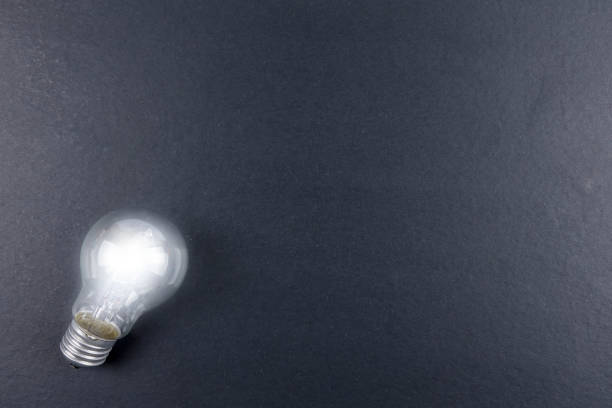 istock Idea concept word IDEA. Light of bulb on grey background. Low light 1200096760