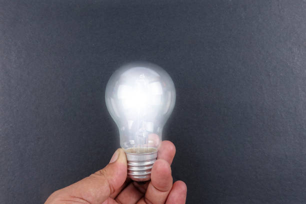 istock Idea concept word IDEA. Light of bulb on grey background. Low light 1200096767
