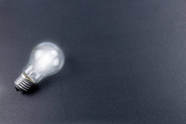 istock Idea concept word IDEA. Light of bulb on grey background. Low light 1200096770
