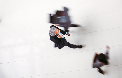 High angle view of business people walking, blurred motion