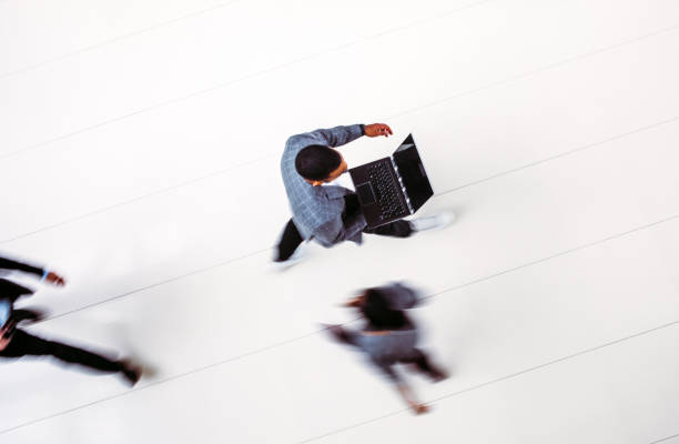 istock High angle view of business people walking, blurred motion 1200098265