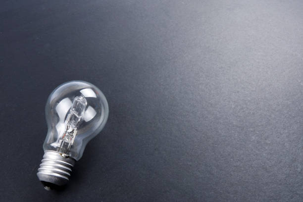istock Idea concept word IDEA. Light of bulb on grey background. Low light 1200098587