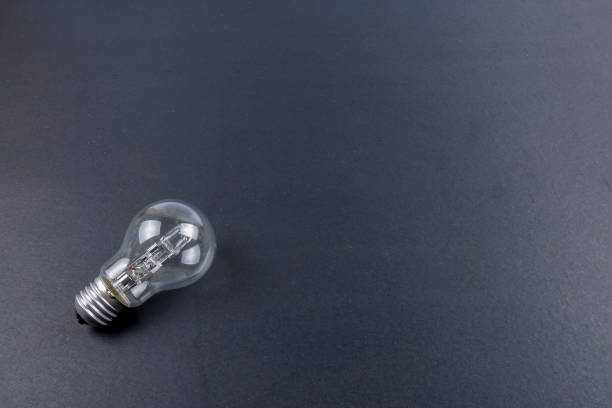 istock Idea concept word IDEA. Light of bulb on grey background. Low light 1200098595