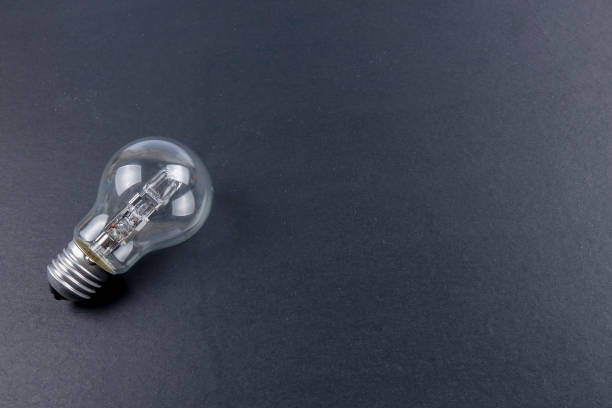 istock Idea concept word IDEA. Light of bulb on grey background. Low light 1200098597